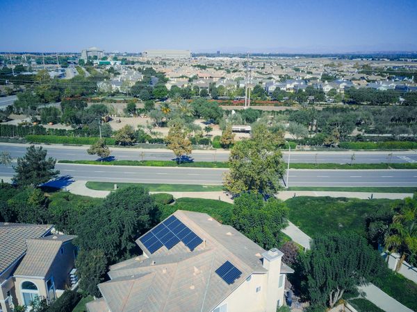 Homes, solar rooftops, and a community served by the electric grid